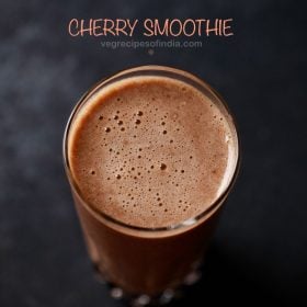 cherry smoothie in a glass with text layovers.