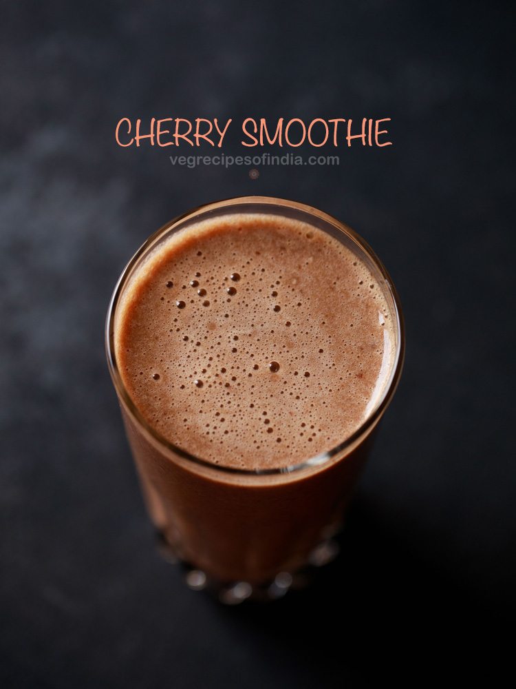 cherry smoothie in a glass with text layovers.