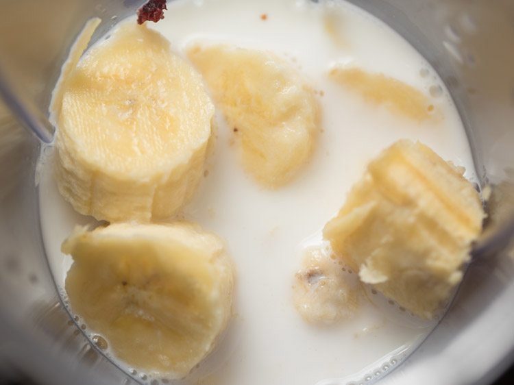 Banana and almond milk in a blender.