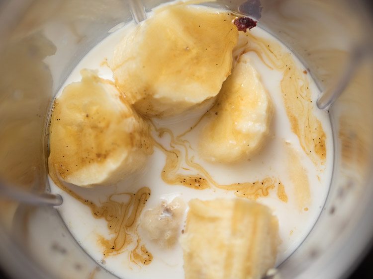 adding vanilla to bananas and almond milk.