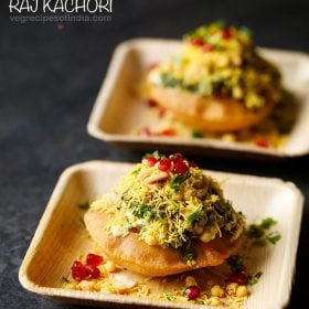 raj kachori served on 2 wooden plates with text layover.
