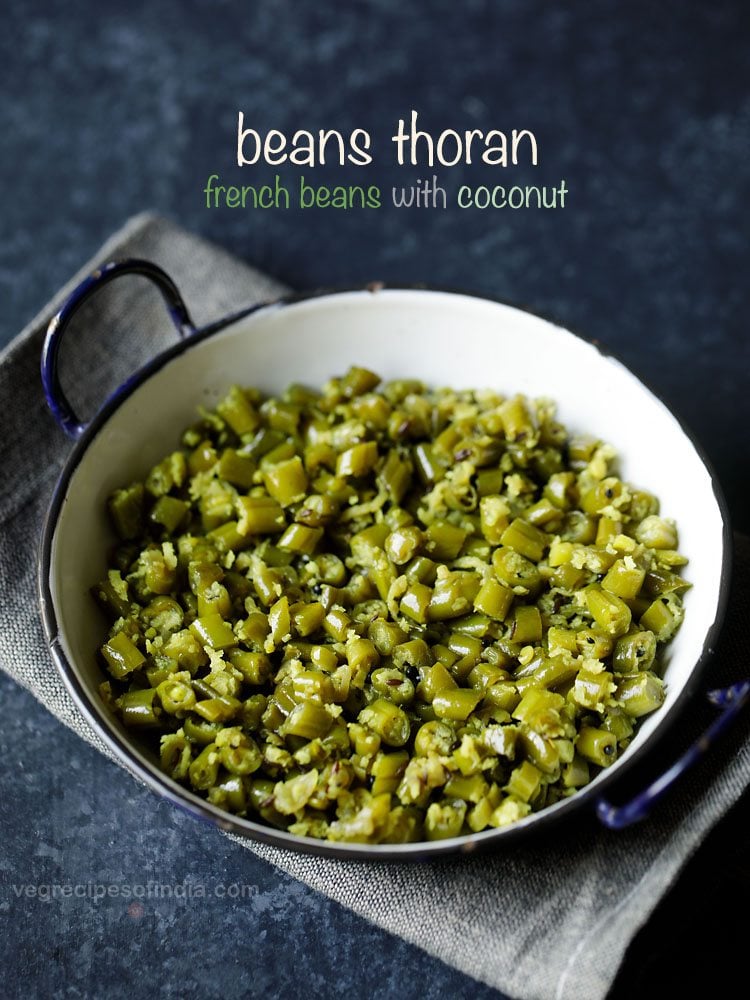 beans thoran served in a black rimmed pot with text layovers.