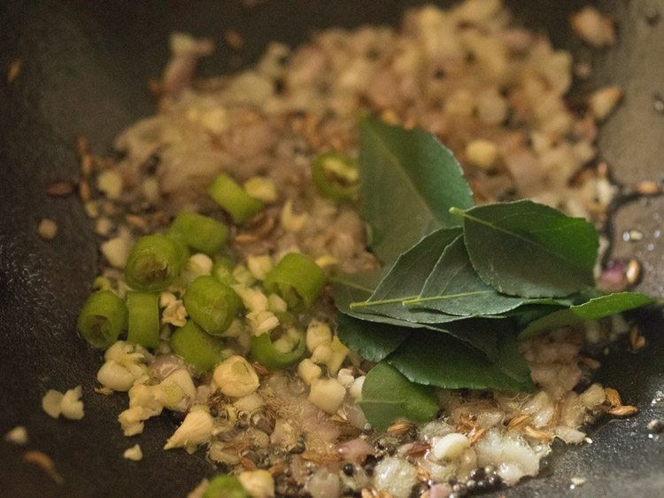 finely chopped garlic, chopped green chili and curry leaves added to pan. 