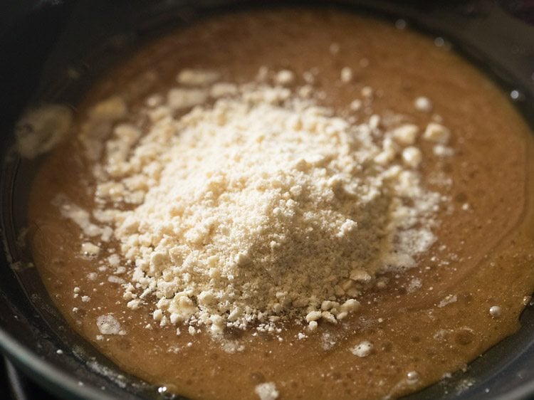 adding crushed cashewnuts to the butter-sugar mixture 