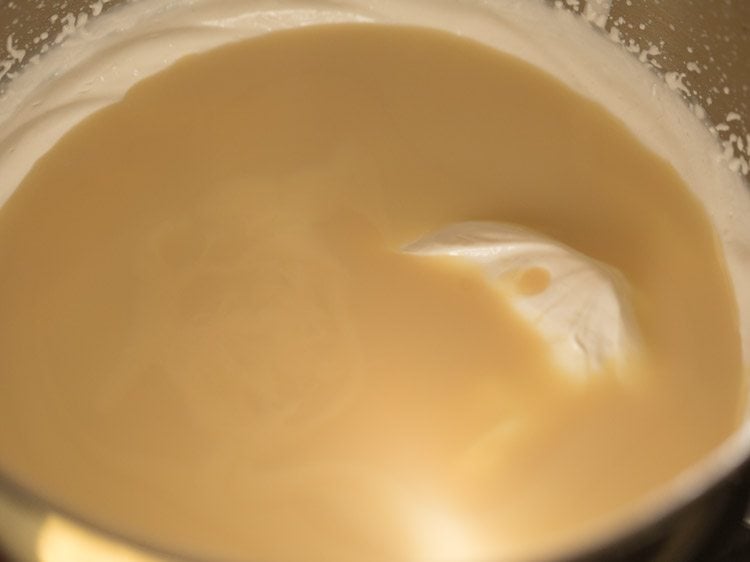 adding chilled condensed milk to whipped cream
