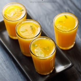 a serving tray filled with garnished glasses fruit punch.