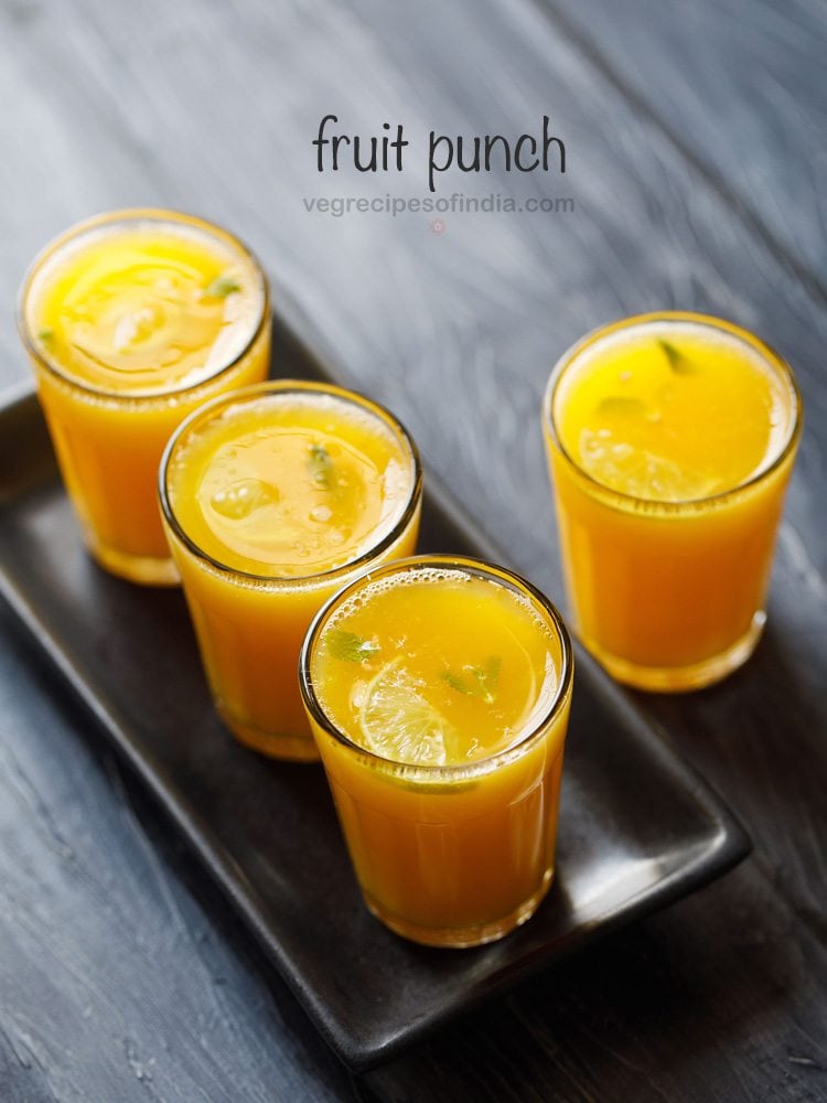 a serving tray filled with garnished glasses of fruit punch.