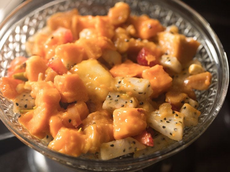 fruit salad mixture added to a bowl. 