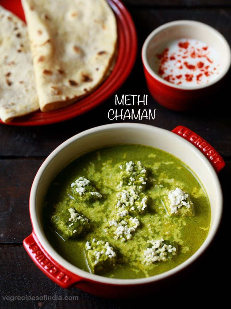 methi chaman served in a red casserole with a red plate of chapattis and a bowl of curd kept in the background and text layover.