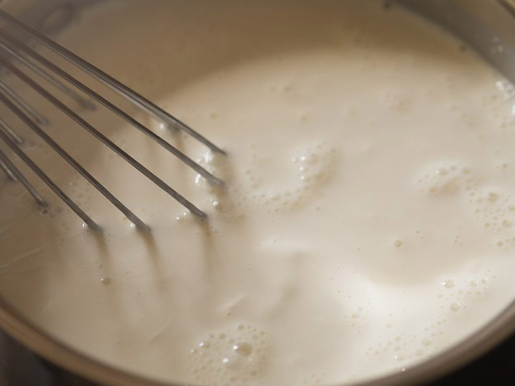 whisking cream milk and sugar to dissolve the sugar over medium heat