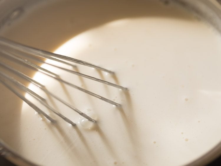 whisking vanilla into cream base for panna cotta