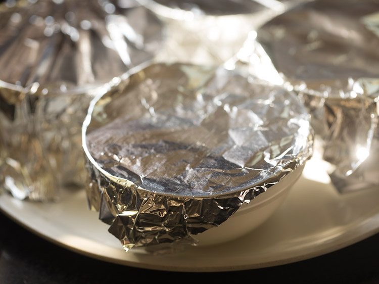 vegetarian panna cotta in bowls covered with foil for refrigeration