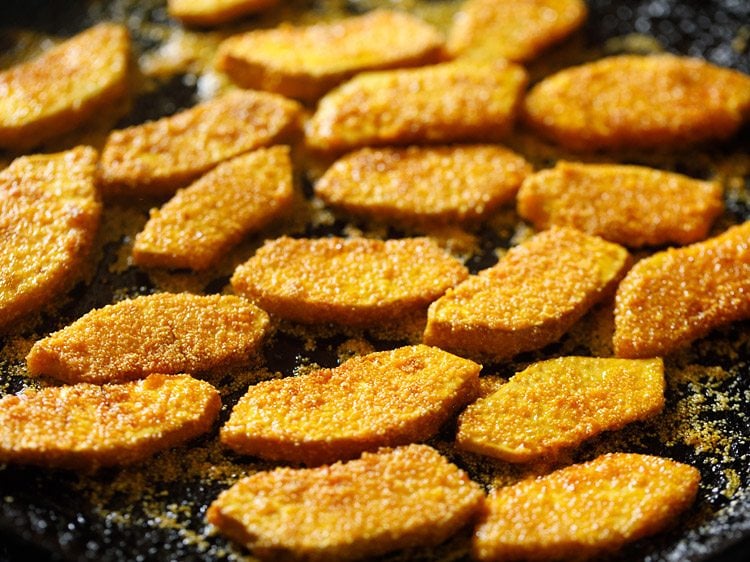 frying breadfruit slices in hot oil. 