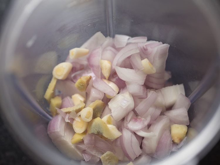 roughly chopped onions, chopped garlic and chopped ginger added in a blender jar. 