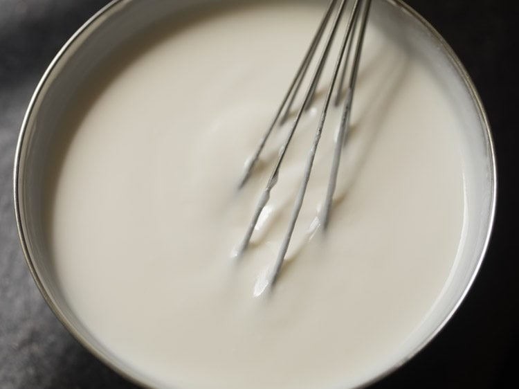 whisking curd to smooth. 