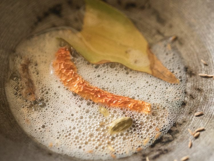 whole spices added to hot ghee or oil in a pan. 