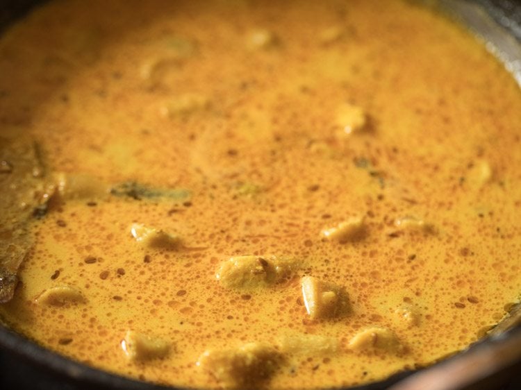 gatte pieces stirred gently into the curd gravy. 