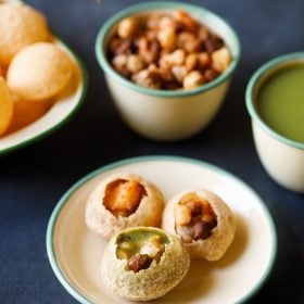 golgappa assembled and served on a green rimmed plate with the elements kept in the background and text layover.