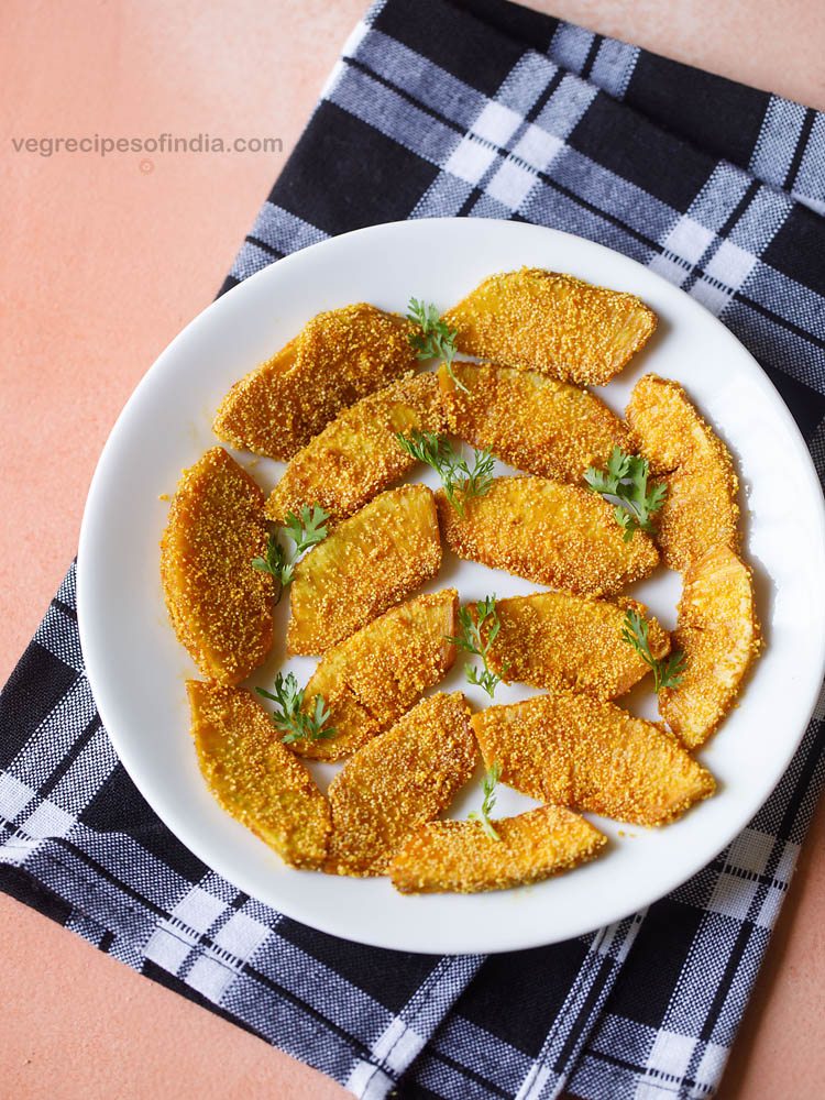 breadfruit fry garnished with coriander leaves and served on a white plate. 