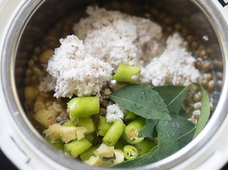 chopped green chilies, chopped ginger, curry leaves and fresh grated coconut added to grinder jar for making paste for mor kuzhambu. 