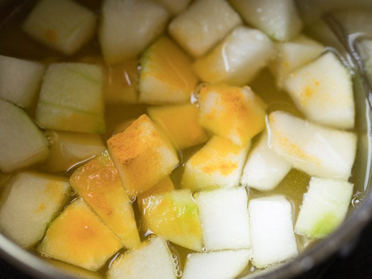 turmeric powder and salt added to pan for mor kuzhambu. 