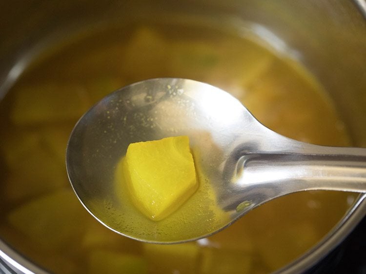 cooked ash gourd cube on a spoon. 