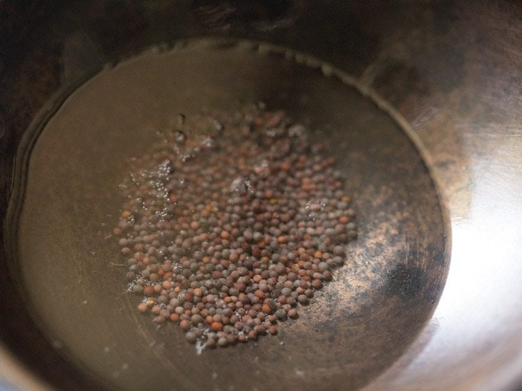 mustard seeds added to hot oil. 
