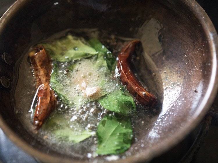 curry leaves and asafoetida added to hot oil. 