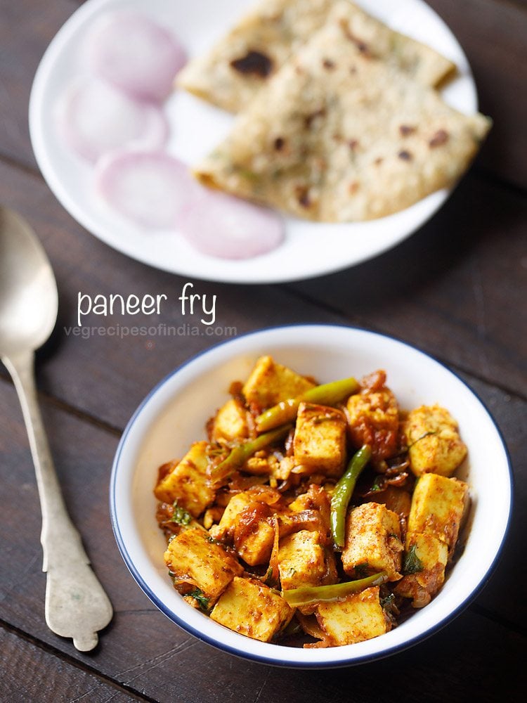 paneer fry served in a white bowl with a spoon kept on the left side, chapattis and onion rings kept on a white plate on the top side and text layovers.