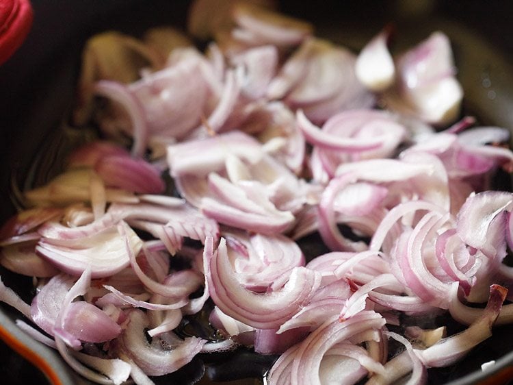 thinly sliced onions added to hot oil in pan. 