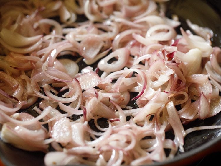 sautéing onions in the pan. 