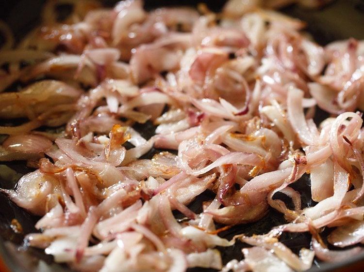 sautéing onions in the pan to make paneer fry recipe.