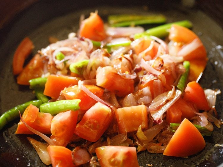 sautéing onion-tomato mixture in the pan. 