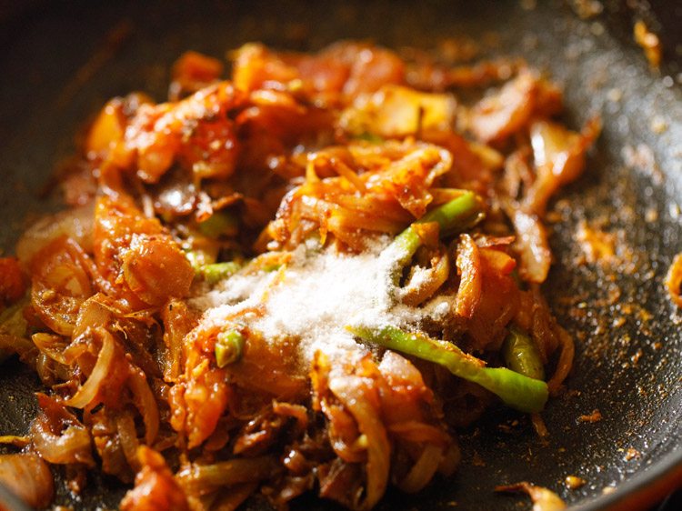 salt added to the spiced onion-tomato fry mixture. 