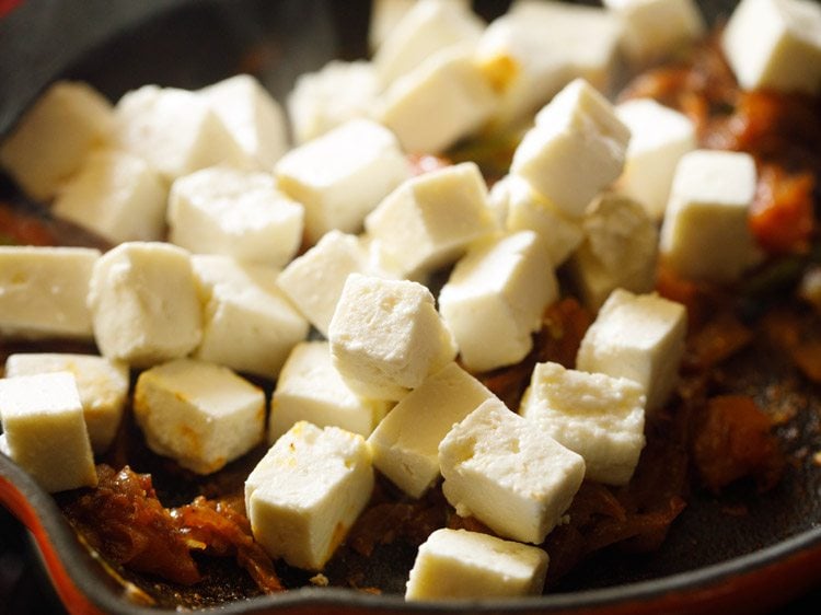 paneer cubes added to the spiced onion-tomato mixture. 