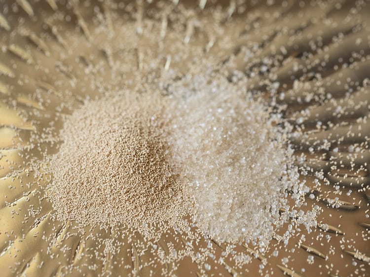 instant yeast and sugar added in a tray. 