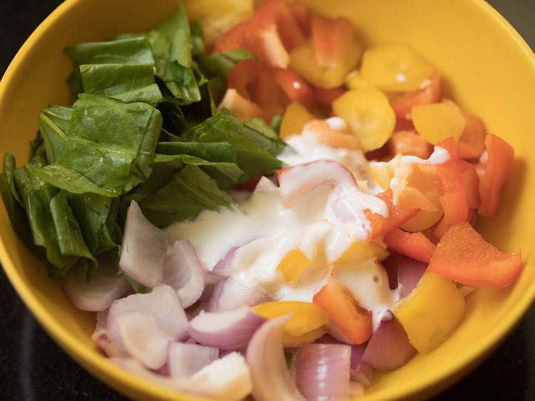 fresh curd added to the vegetables in the bowl. 