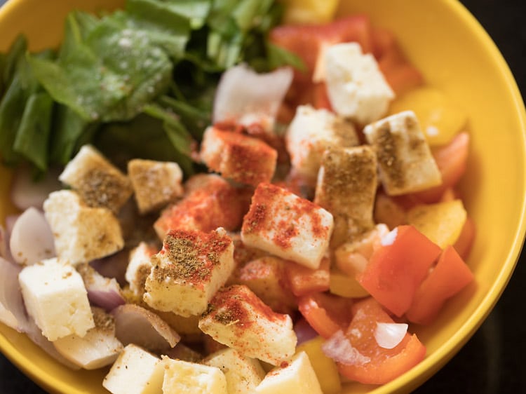 red chili powder, cumin powder, garam masala powder and salt added to the vegetable-paneer mixture in the bowl. 