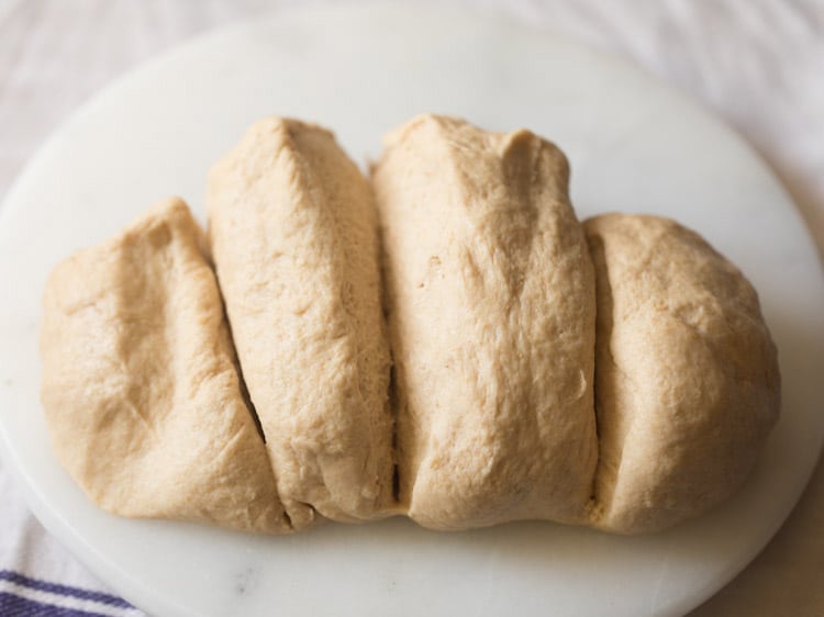 slicing the leavened dough into equal parts. 