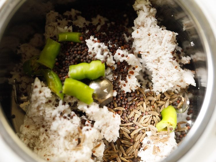 coconut, spices, and green chile in a grinder jar.