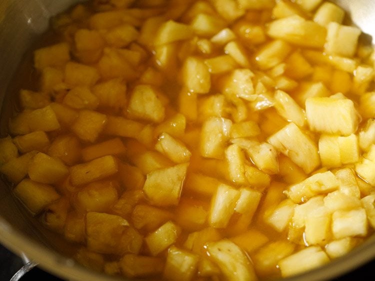 cooking pineapple for pachadi recipe.