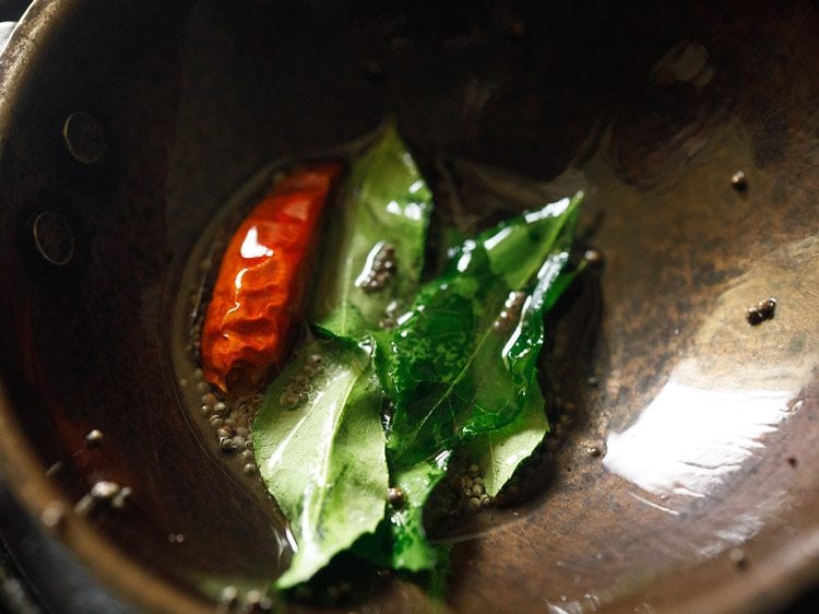 the red chile has become brighter and the curry leaves are darker green and slightly crisp.