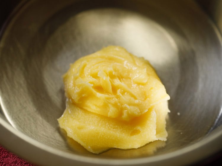 ghee added in a bowl for making badusha. 