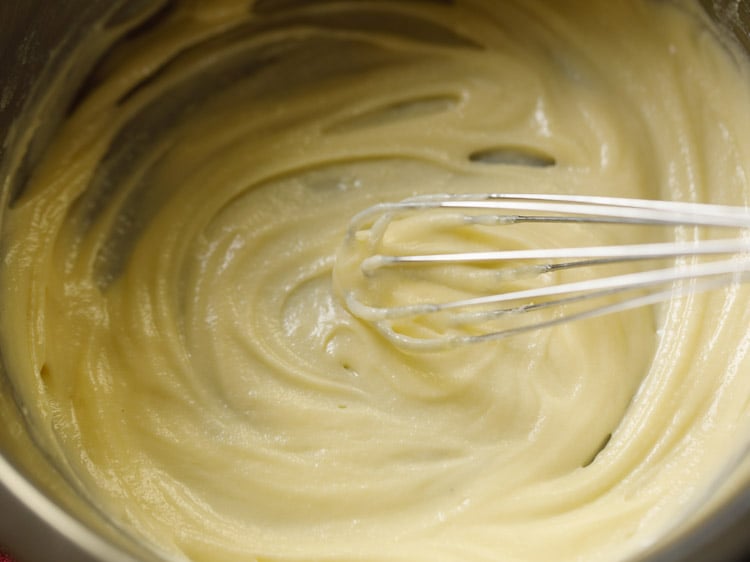 beating ghee with a wired whisk till smooth for making badusha. 