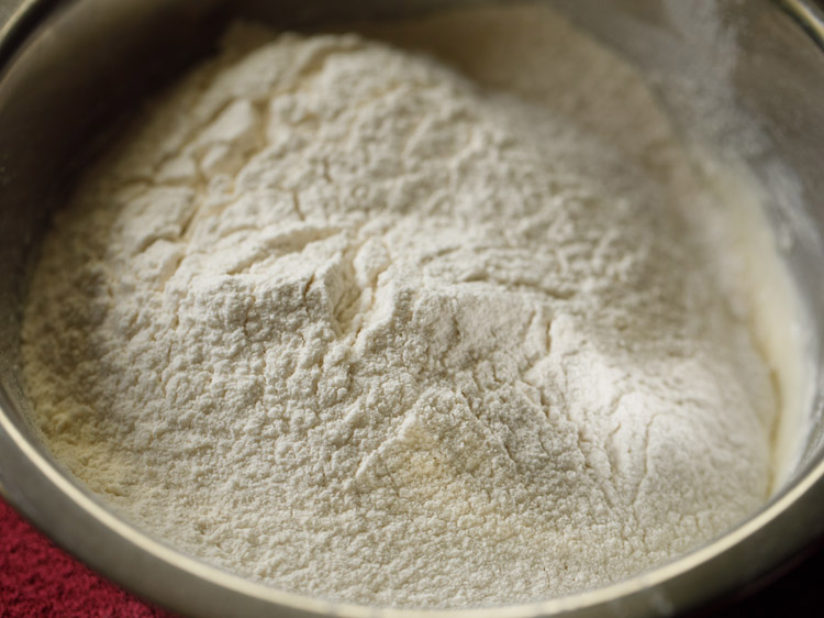 flour sifted directly into the creamed mixture for making badusha. 