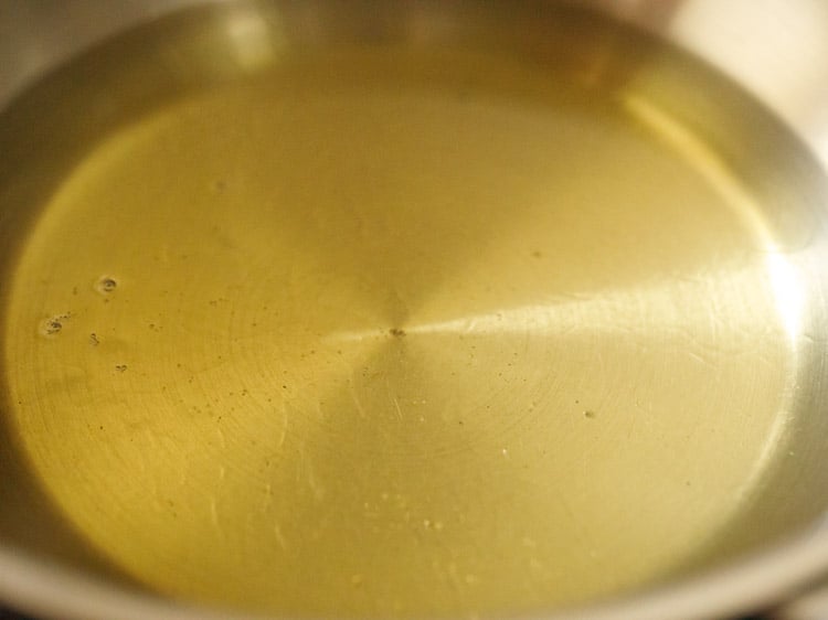 heating oil in a pan for frying balushahi sweet. 