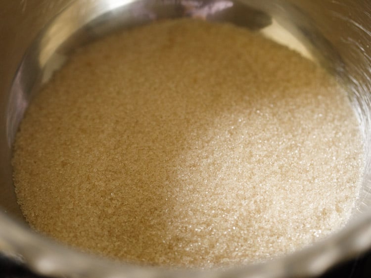 sugar added to a pan for making sugar syrup for badusha sweet. 
