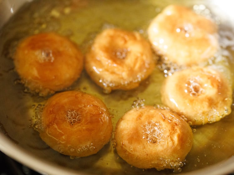 frying balushahi recipe in hot oil till golden. 