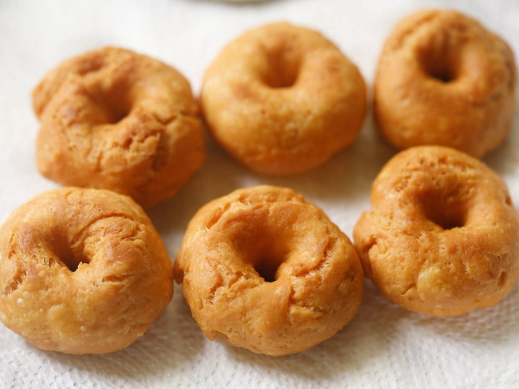 fried balushahi recipe placed on kitchen paper towel. 