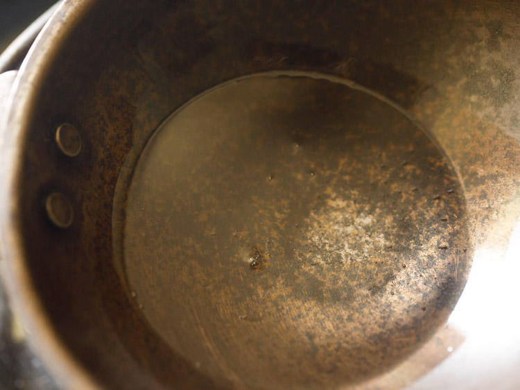 heating coconut oil in a small pan for making tempering. 